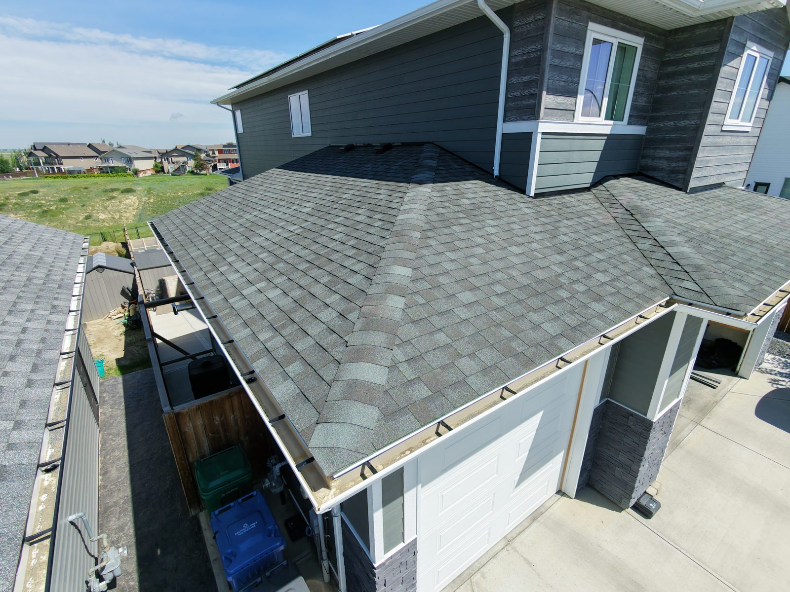 Aerial close-up of a grey shingle roof treated with NuRoof over a garage